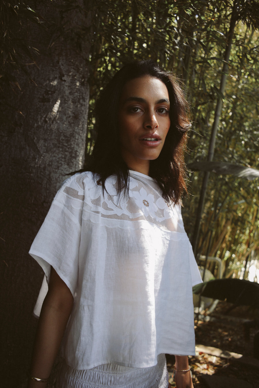 White, 100% linen short-sleeve t-shirt with a drop armhole, loose fit and appliqué  floral embroidery on a semi-sheer cotton tulle yoke.