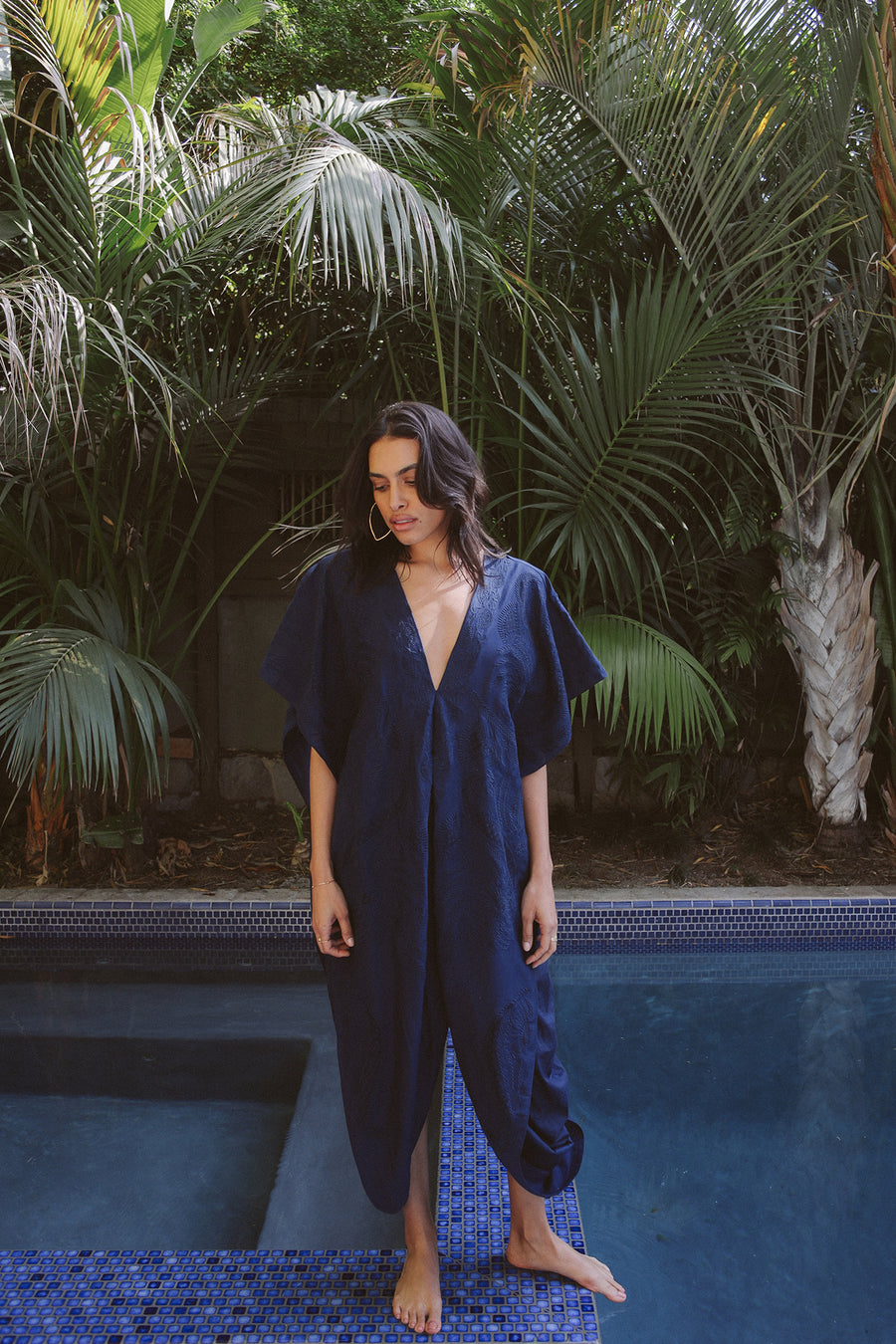 Pull over indigo embroidered kaftan with deep-v neckline and side opening at waist.